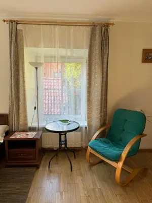 a room with a chair and a table and a window at Tilto 6 in Vilnius