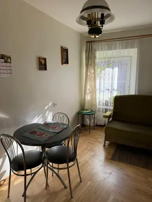 a living room with a table and chairs and a couch at Tilto 6 in Vilnius