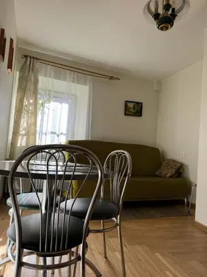 a living room with a table and chairs and a couch at Tilto 6 in Vilnius