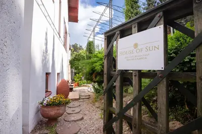 a gate to a house of sun with a sign on it at House of Sun in Vilnius