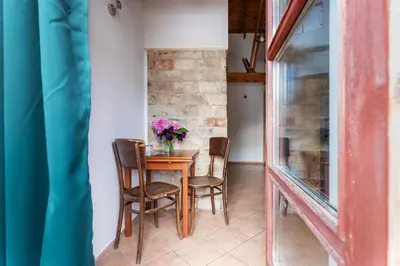 a table with chairs and a vase of flowers at House of Sun in Vilnius