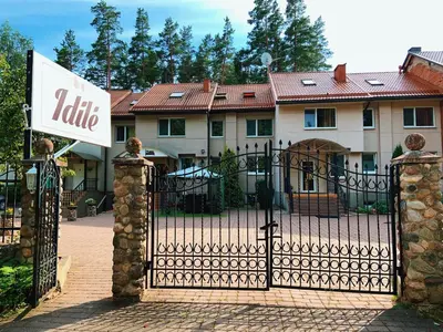 a gate to a house with a latrine sign on it at Idilė Bed & Breakfast - Visaginas in Visaginas