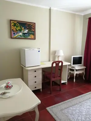 a room with a desk with a computer and a chair at Idilė Bed & Breakfast - Visaginas in Visaginas
