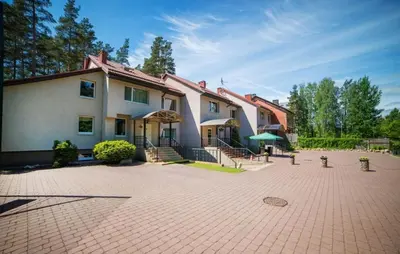 a large house with a brick driveway in front of it at Idilė Bed & Breakfast - Visaginas in Visaginas