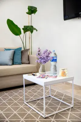 a white coffee table in a living room with a couch at Stay in Kaunas - Free Parking in Kaunas