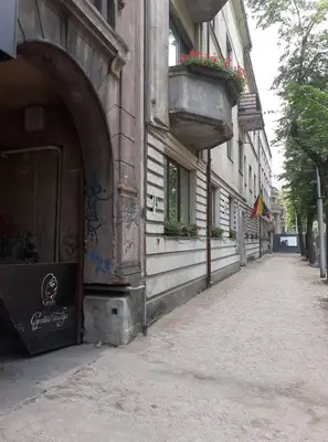 an empty street next to a building with flower boxes at Stay in Kaunas - Free Parking in Kaunas