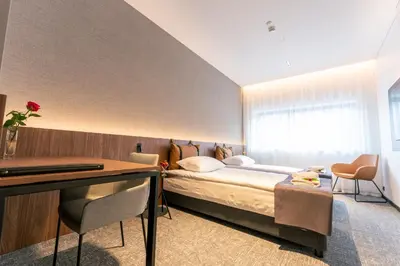 a hotel room with a bed and a desk at Pan Tadeusz in Vilnius