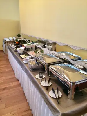 a buffet line of food on a long table at Pan Tadeusz in Vilnius