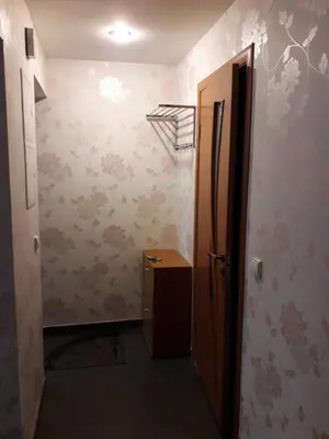 a hallway with a door to a room with wallpaper at Laisves al. 7 in Kaunas