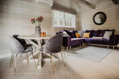 a living room with a purple couch and a table at 5 stories in Inkartai