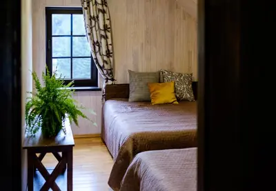 a small room with a bed and a window at 5 stories in Inkartai