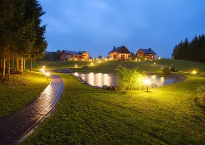 a house on a hill next to a river at night at 5 stories in Inkartai