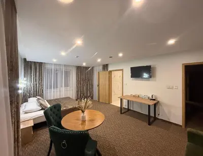 a hotel room with a bed and a table at Simona House in Šiauliai