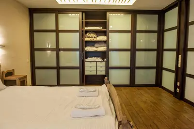 a bedroom with a bed with two towels on it at Natalex Europe in Vilnius