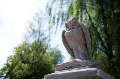 a statue of an owl sitting on top of a statue at Loft on Owl Hill in Kaunas