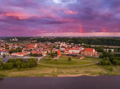 an aerial view of a town with a rainbow in the sky at Loft on Owl Hill in Kaunas