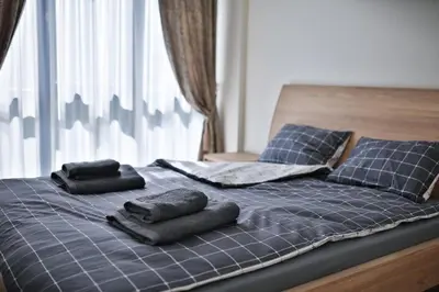 a bed with two pillows on top of it at Loft on Owl Hill in Kaunas
