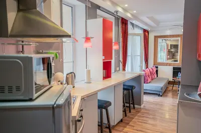 a kitchen with a counter top with a microwave at Alpetri Apartments in Kaunas