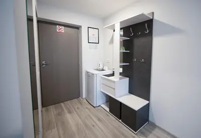 a small bathroom with a sink and a toilet at Dzūkija Hotel in Alytus