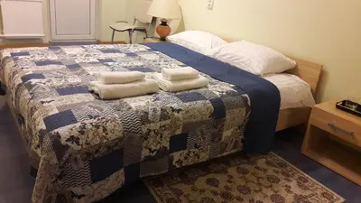 a bedroom with a bed with two towels on it at Gražinos apartamentai in Panevėžys