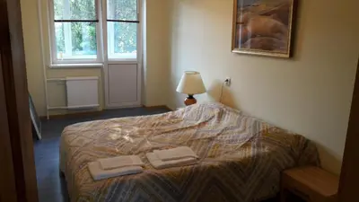 a bedroom with a bed with two towels on it at Gražinos apartamentai in Panevėžys