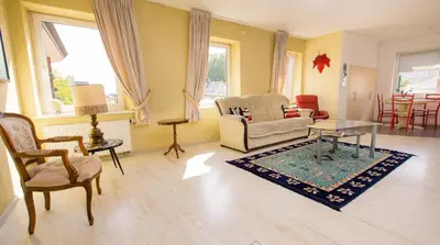 a living room with a couch and a table at Old Town Apartments in Alytus