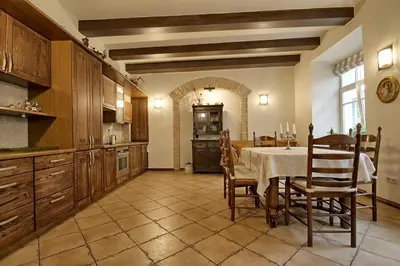 a kitchen with a table and chairs in a room at Pilies Apartments in Vilnius