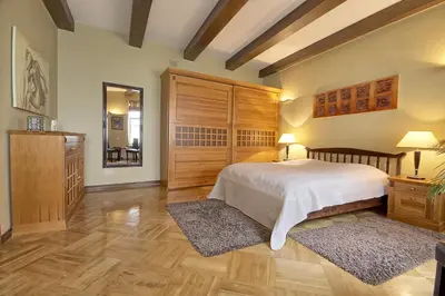 a bedroom with a bed and a dresser and a mirror at Pilies Apartments in Vilnius