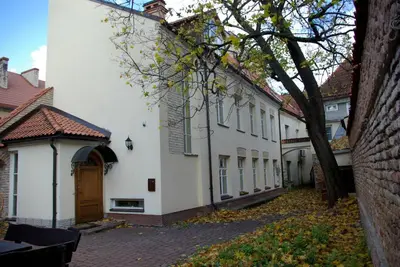 a group of white buildings on a street at Pilies Apartments in Vilnius