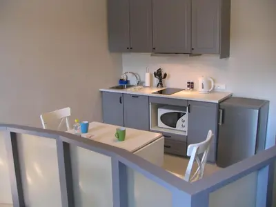 a small kitchen with a table and a microwave at Studio 59 in Kaunas