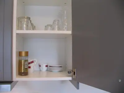 a cupboard filled with dishes and glass jars at Studio 59 in Kaunas
