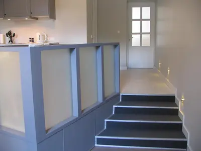 a staircase leading up to a kitchen with a window at Studio 59 in Kaunas