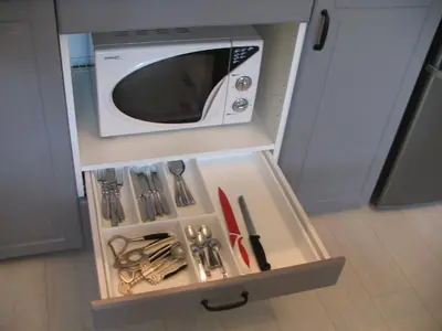 a drawer in a cabinet filled with kitchen utensils at Studio 59 in Kaunas