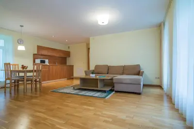 a living room with a couch and a table at Guest House Milda in Druskininkai