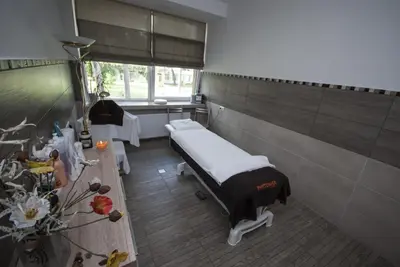 a hospital room with a bed and a table at Hotel Dainava in Druskininkai