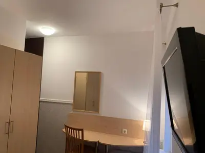 a room with a table and a mirror on the wall at Broliu Vila in Druskininkai