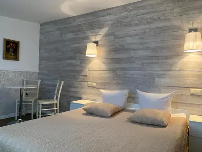 a bedroom with a bed with two pillows on it at Broliu Vila in Druskininkai