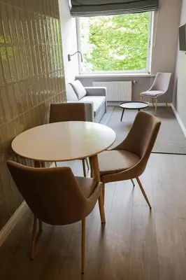 a room with a table and chairs and a couch at Guest House Senasis Pastas in Druskininkai