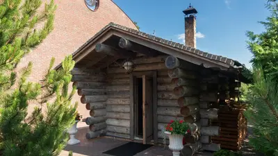 an outside view of a log cabin with a door at Harmony Park Hotel & SPA in Prienai