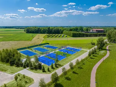an overhead view of a pool in a grassy field at Harmony Park Hotel & SPA in Prienai