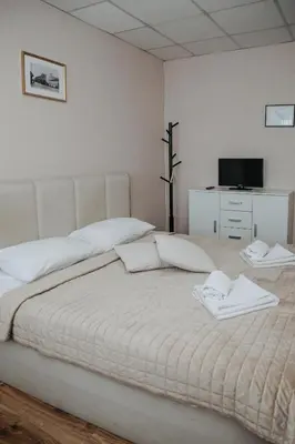 a bedroom with a bed with two towels on it at Verslo Klasė-easy to stay in Panevėžys