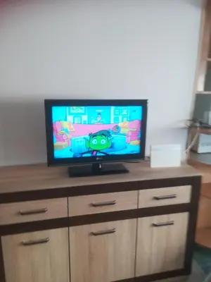 a flat screen tv sitting on top of a dresser at Butas Vilniaus alėjoje in Druskininkai