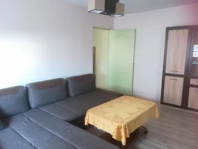 a living room with a couch and a table at Butas Vilniaus alėjoje in Druskininkai