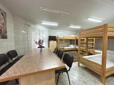 a room with a table and chairs and bunk beds at Nakvisa in Zarasai