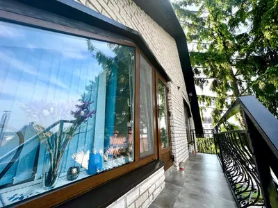 a window on a building with a view of the ocean at Nakvisa in Zarasai