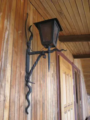 a lantern hanging on the wall of a room at Salako svečių namai in Salakas