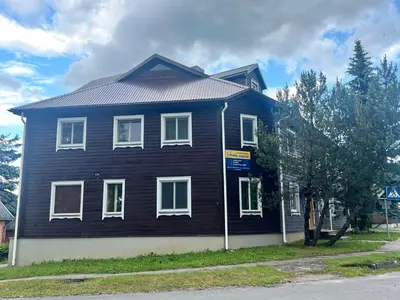 a black house with white windows on a street at Salako svečių namai in Salakas