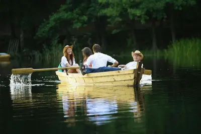 a group of people in a boat on the water at TonyResort in Trakai