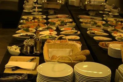 a long table filled with plates and bowls of food at TonyResort in Trakai