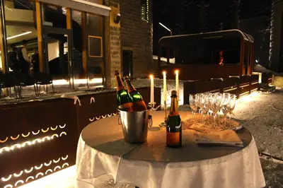 a table with bottles of wine and glasses on it at TonyResort in Trakai
